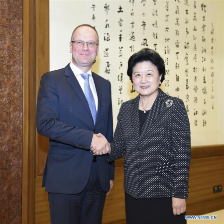 Chinese Vice Premier Liu Yandong(R) shakes hands with Tibor Navracsics, the chair of China-EU high-level people-to-people dialogue from the EU side, and EU Commissioner for Education, Culture, Youth and Sport, in Beijing, capital of China, Oct. 10, 2016. (Photo: Xinhua/Zhang Ling)