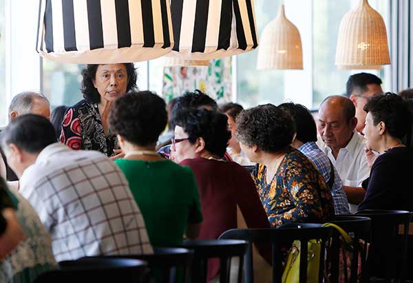 Elderly people socialize outside a restaurant operated by Swedish furniture giant Ikea in Shanghai's Xuhui district on Tuesday.(Yin Liqin/For China Daily)