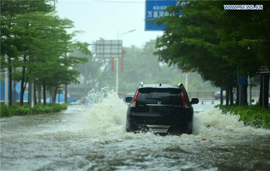 A vehicle runs on flooded road in typhoon-hit Qionghai City, south China's Hainan Province, Oct. 18, 2016. Typhoon Sarika, the 21st typhoon of the year, made landfall at Hainan Province Tuesday morning. The tropical cyclone, packing maximum winds of 162 km per hour, landed at Hele Town, Wanning City, at 9:50 a.m., according to local meteorological bureau. (Xinhua/Meng Zhongde) 