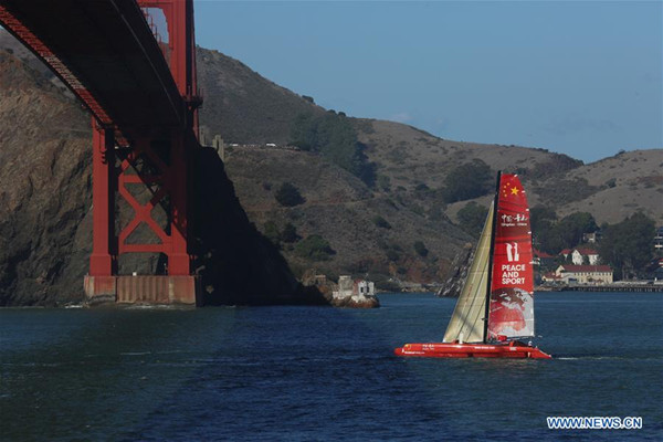Chinese mariner Guo Chuan sails his trimaran under San Francisco's Golden Gate Bridge, the United States, embarking on a solo trans-Pacific voyage with Shanghai, China, as the destination, Oct. 18, 2016. He aims to complete the voyage within 20 days to set a new solo non-stop trans-Pacific sailing world record from San Francisco to Shanghai. The current record is 21 days set by crews of Italian Maserati. (Photo/Xinhua)