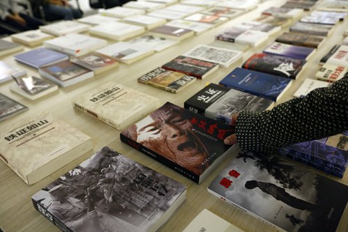 A visitor picks out a book on China's comfort women Saturday at a newly opened museum at Shanghai Normal University.
