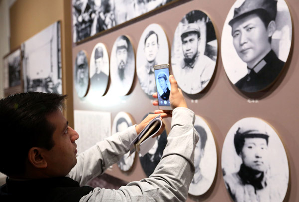Akhil Parashar from India views the Long March exhibition in Beijing on Monday. (Photo by WANG ZHUANGFEI/CHINA DAILY)