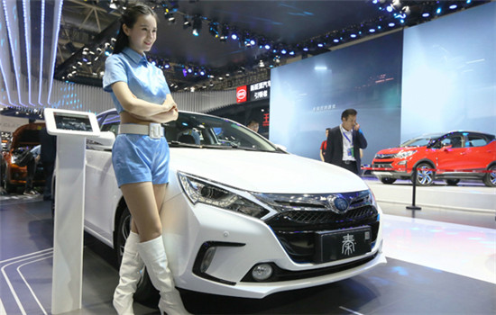 A model stands beside a BYD car at an auto expo in Beijing. (Photo provided to China Daily)
