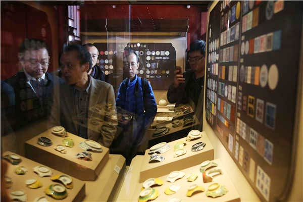 Visitors look at the ongoing exhibitions that showcase ceramics made in China's porcelain hub, Jingdezhen, for imperial courts during the Ming and Qing dynasties at the Palace Museum in Beijing. The imperial-kiln ceramics represent a zenith in the country's porcelain-making history. Photos by Jiang Dong/China Daily