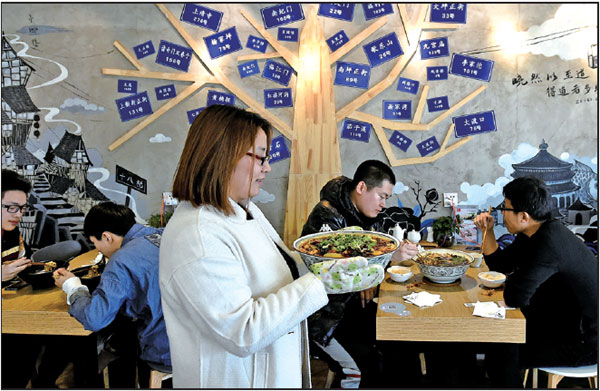 Zhang serves a dish to customers at her restaurant.