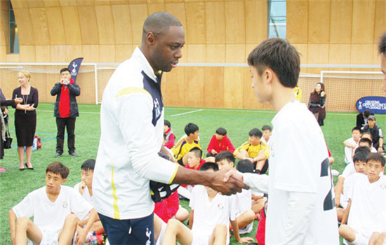 Ledley King greets young players during the launch of the Jaguar Football Campus Guangzhou in September. (Photo/China Daily)