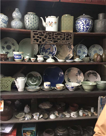 A cupboard filled with various types of china.
