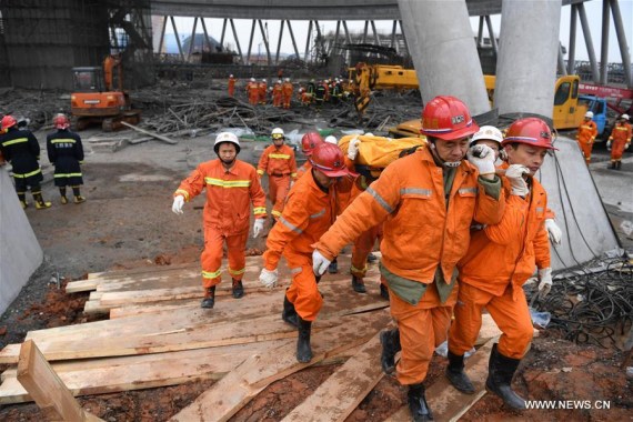 Rescuers work at the accident site at the Fengcheng power plant in Yichun City, east China's Jiangxi Province, Nov. 24, 2016. Sixty-seven people have been confirmed dead and another missing as a platform of a power plant's cooling tower under construction collapsed in Jiangxi Thursday, rescuers said. (Photo: Xinhua/Wan Xiang)