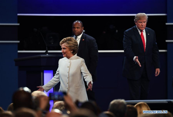 Republican presidential candidate Donald Trump (R) and Democratic presidential candidate Hillary Clinton (front) participate in the third and final presidential debate at the University of Nevada Las Vegas (UNLV) in Las Vegas, Nevada, the United States, Oct. 19, 2016.(Photo: Xinhua/Yin Bogu)