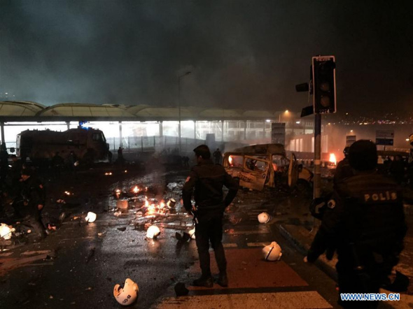 Policemen check the site of explosions in central Istanbul, Turkey, on Dec. 10, 2016. Two explosions hit central Istanbul on Saturday night, injuring 20 people, the authorities said. The blasts happened within 10 seconds at the conclusion of a football match in the district of Besiktas, and a car was seen burning in front of the stadium, the Haberturk daily said. (Xinhua)