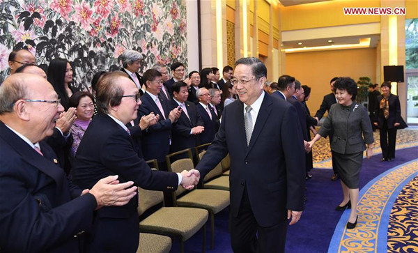 Yu Zhengsheng, chairman of the National Committee of the Chinese People's Political Consultative Conference, meets with a visiting delegation from the Hong Kong Chiu Chow Chamber of Commerce at the Diaoyutai State Guesthouse in Beijing, capital of China, Dec. 13, 2016. (Xinhua/Zhang Duo)