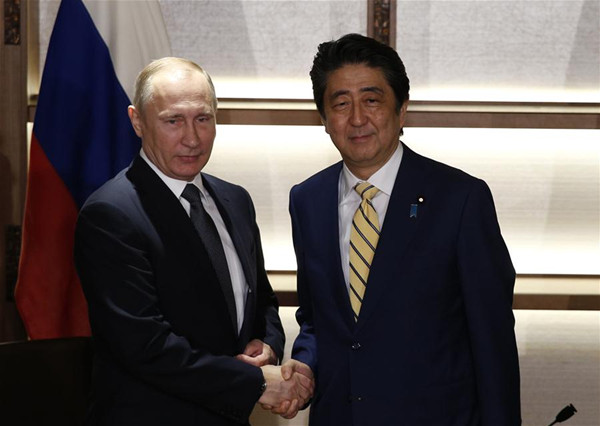 Russian President Vladimir Putin (L) shakes hands with Japanese Prime Minister Shinzo Abe prior to their meeting in Nagato, Yamaguchi prefecture, Japan, Dec. 15, 2016. Russian President Vladimir Putin held talks with Japanese Prime Minister Shinzo Abe here on Thursday focusing on a decades-old territorial dispute and a post-war peace treaty. (Xinhua)