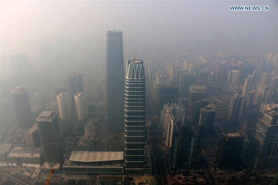 Photo taken on Dec. 17, 2016 shows buildings enveloped in smog in Beijing, capital of China.(Photo Xinhua/Jin Liangkuai)