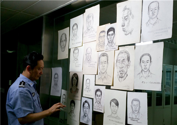 Lin Yuhui checks some of the sketches he has drawn of people in public places. (Photo provided to China Daily)