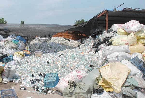 Large piles of medical waste sit at a dump site near Gujia village in Nanjing. (Photo/China Daily)