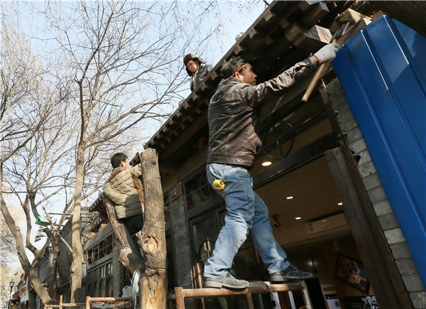 Restoration work is underway in Beijing's Nanluoguxiang earlier this month. (Photo by Sun Yue/For China Daily)