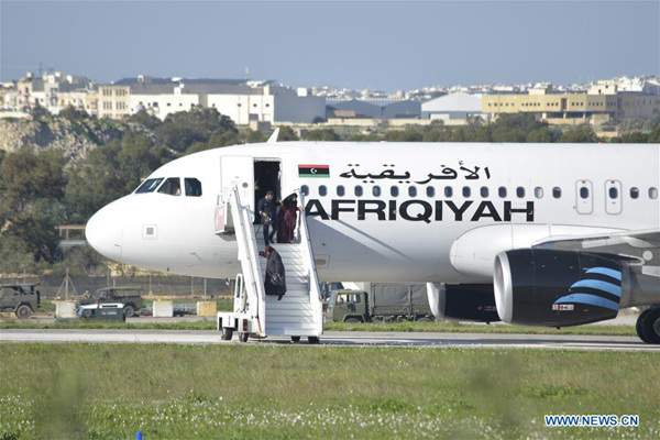 The released people from the hijacked Libyan plane step off the plane at Malta International Airport, Valletta, Malta, on Dec. 23, 2016. The two hijackers of a Libyan internal flight have surrendered, searched and taken into custody at the Malta International Airport, Maltese Prime Minister Joseph Muscat said Friday on Twitter. (Xinhua/Mark Zammit Codina)