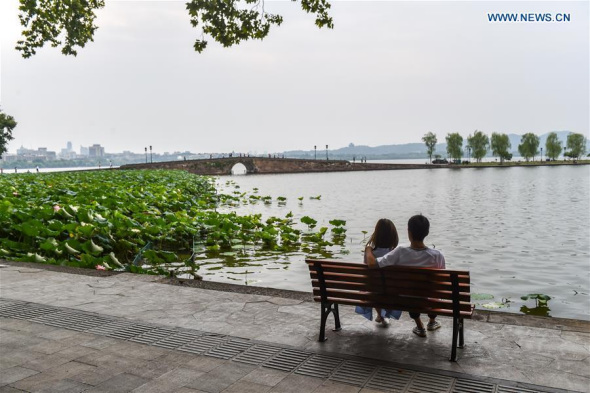 A couple watches the view of the West Lake in Hangzhou, capital of east China's Zhejiang Province, Sept. 1, 2016.(Xinhua/Huang Zongzhi)
