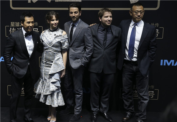 A promotional event is held in Beijing for the upcoming Rogue One: A Star Wars Story, featuring (from left) Donnie Yen, Felicity Jones, Diego Luna, director Gareth Edwards and actor Jiang Wen. (Photo by Feng Yongbin/China Daily)