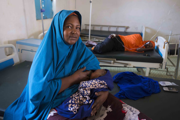 Malyuum Osman, 29, rests with her one-day-old newborn, Mohamed. Photo Provided By UNICEF