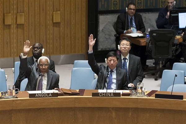 Wu Haitao(R, front), China's deputy permanent representative to the United Nations, votes in favor of a Security Council resolution endorsing the Syria cease-fire arrangement brokered by Russia and Turkey as well as the new peace talks plan among Syrian conflict parties at the UN headquarters in New York, Dec. 31, 2016. The UN Security Council on Saturday unanimously adopted a resolution supporting the Syria cease-fire arrangement brokered by Russia and Turkey as well as a new peace talks plan among Syrian conflict parties. (Xinhua/Li Muzi)