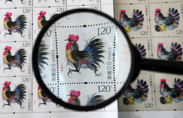 Rooster-themed stamps to celebrate the Year of the Rooster are displayed at a post office in Weifang, Shandong province, on Tuesday.Zhang Chi / For China Daily