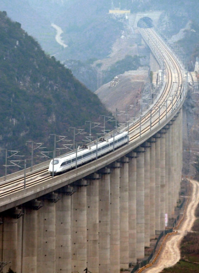 A train crosses a bridge in Guizhou province on Dec 29, the first day of operations for the Kunming-Guiyang high-speed railway.Zou Hong / China Daily