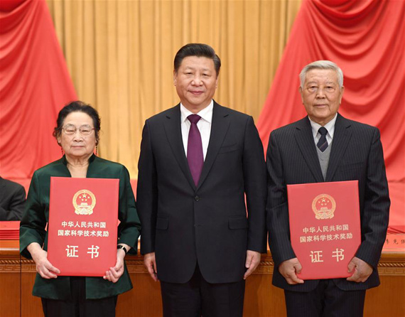 Chinese President Xi Jinping (C) presents award certificates to physicist Zhao Zhongxian (R) and pharmacologist Tu Youyou, who won China's top science award, at an annual ceremony held to honor distinguished scientists and research achievements in Beijing, capital of China, Jan. 9, 2017. (Xinhua/Li Xueren)