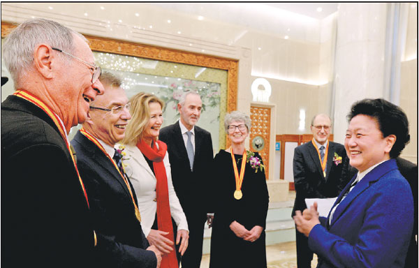 Vice-Premier Liu Yandong (right) interacts with winners of the International Science and Technology Cooperation Award and their families after an annual ceremony was held to honor distinguished scientists and research achievements in Beijing on Monday.Zhou Weihai / For China Daily