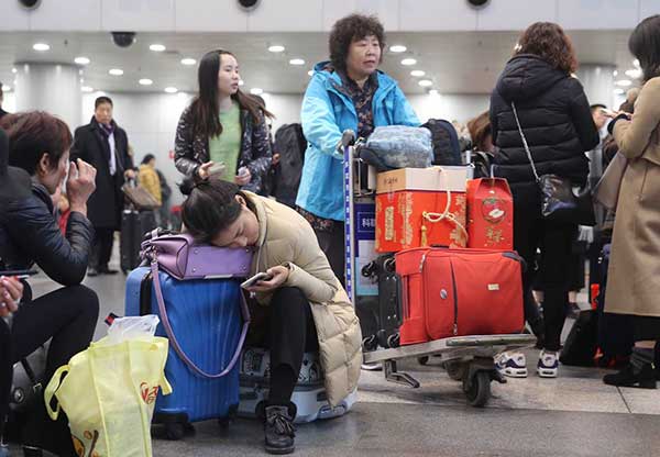 Passengers are stranded at Beijing Capital International Airport due to flight delays caused by heavy smog in December.Feng Yongbin / China Daily