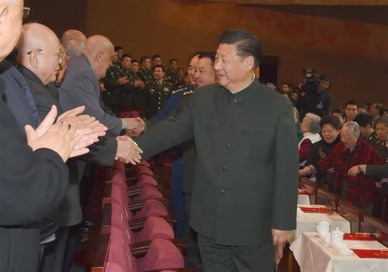 Chinese President Xi Jinping, also general secretary of the Communist Party of China (CPC) Central Committee and chairman of the Central Military Commission, shakes hands with military veterans and ex-officers at a festive art performance held for them in Beijing, capital of China, Jan. 13, 2017. (Xinhua/Li Gang)