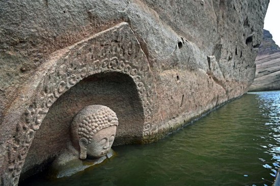 A Buddha head emerges from the water of the Hongmen reservoir in Nancheng county, east China's Jiangxi Province, Jan. 8, 2017. (Photo: Xinhua/Wan Xiang)