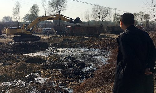 A man looks at the acid lake discovered between Jiaocheng and Wenshui counties in North China's Shanxi Province. (Photo/Courtesy of Cao Haidong)