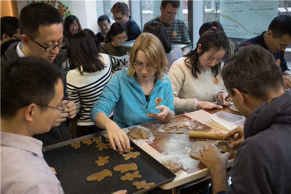 Employees of the Shanghai branch of the German company Brose participate in a team-building activity at the Village 127 French Bakery and Cafe. (Photo by Gao Erqiang/China Daily)