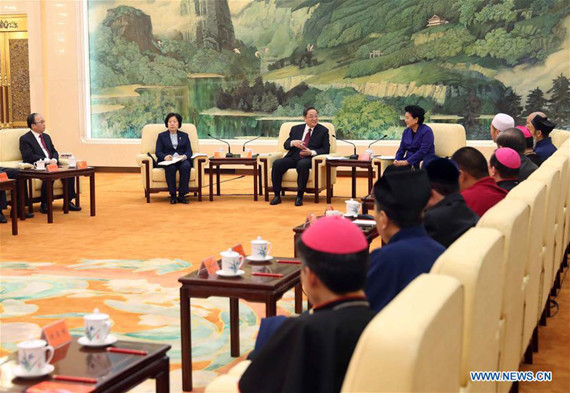 Yu Zhengsheng (3rd L, rear), chairman of the National Committee of the Chinese People's Political Consultative Conference, talks at a symposium with leaders of national religious groups ahead of the Spring Festival, or the Chinese Lunar New Year, in Beijing, capital of China, Jan. 24, 2017. (Xinhua/Liu Weibing)