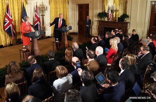 U.S. President Donald Trump and British Prime Minister Theresa May hold a joint press conference at the White House in Washington D.C., the United States, Jan. 27, 2017. U.S. President Donald Trump said Friday that it is very early to talk about lifting sanctions on Russia in relation to the Ukraine crisis. (Xinhua/Yin Bogu)