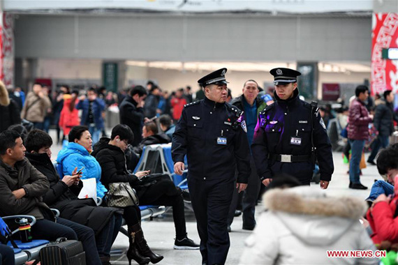 Police officers Gao Yang (C-L) and Nie Yingjie (C-R) patrol at the Changchun Railway Station during Spring Festial travel rush in northeast China's Jilin Province, Jan. 26, 2017. (Xinhua/Zhang Nan)