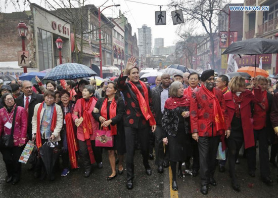 Canada's Prime Minister Justin Trudeau (C) participates in the Chinese Lunar New Year parade in Vancouver, Canada, Jan. 29, 2017. More than 70 parade troops with 3,000 participants paraded along the streets of Chinatown to celebrate the Year of the Rooster. (Xinhua/Liang Sen)