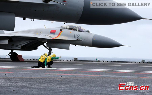 China's homegrown J-15 carrier-borne fighter jets, also know as Flying Sharks, made their debut flights over the South China Sea on Monday. (Photo: China News Service/Mo Xiaoliang)
