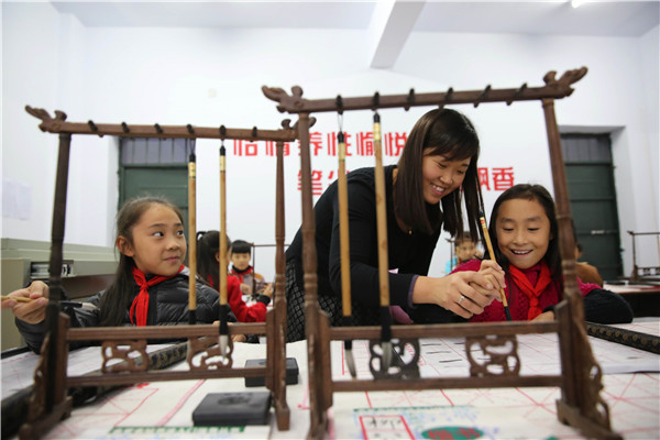 Students practice calligraphy in Wuzhi county, Henan province. The course is part of a free-tuition program run by the local government.Feng Xiaomin / Xinhua