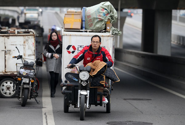 A courier delivers parcels in the Chaoyang district of Beijing.