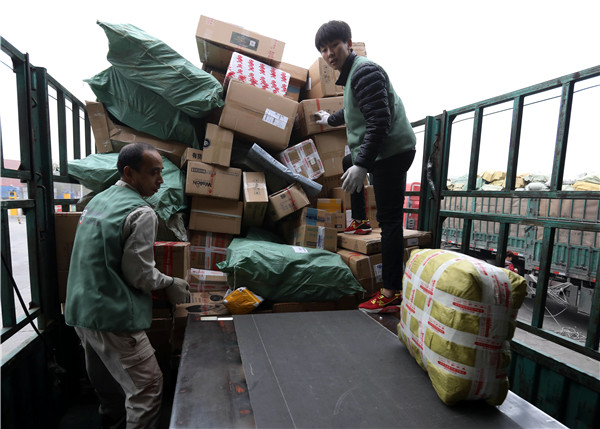 Two couriers unload parcels in Tianjin.
