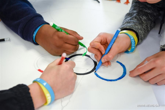 Students draw the Olympic Rings at the Dora Maar secondary school in Seine-Saint-Denis, northeast of Paris, France on Feb. 3, 2017. Paris launched a series of activities promoting Paris' bid to host the 2024 Olympic Games. (Xinhua/Chen Yichen)