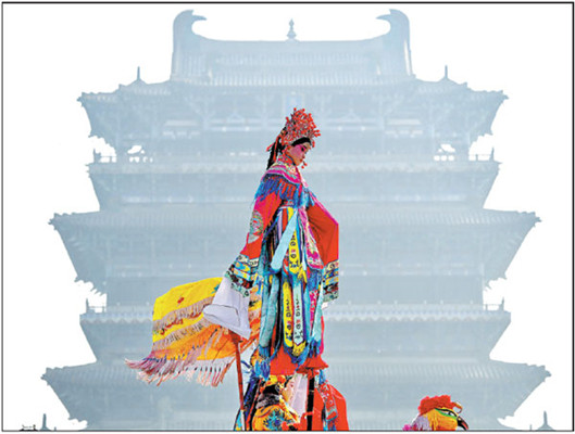 A local person dresses up and performs shehuo, a collection of traditional folk performances, on a foggy day in Yongji, Shanxi province, on Saturday, as part of the city's Spring Festival celebrations. (Photo/For China Daily)