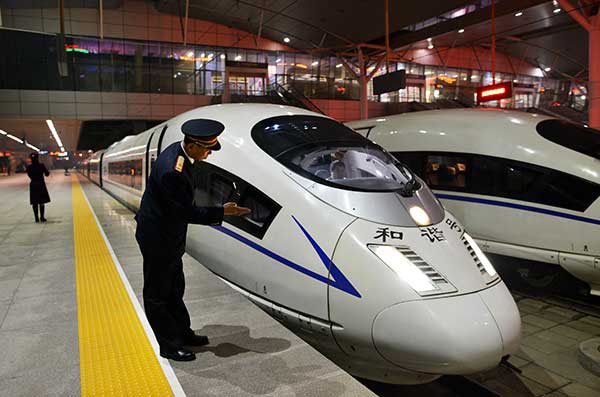 A driver checks a high-speed train before it heads from Tianjin to Beijing South Railway Station on Jan. 25.(Photo/Xinhua)