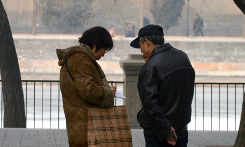 Two parents swap their children's information in Zhongshan Park in central Beijing. Photo: Li Hao/GT