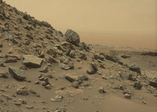 This image take by NASA's Curiosity Mars Rover shows a dramatic hillside outcrop with sandstone layers.