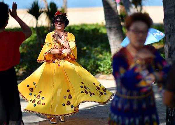 A senior practices dance steps in Sanya, Hainan province. The island has become a haven for elderly Chinese. (Photo/Xinhua)