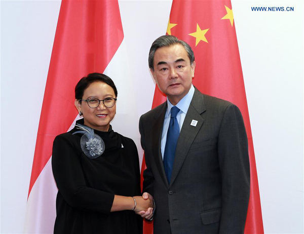 Chinese Foreign Minister Wang Yi (R) shakes hands with his Indonesian counterpart Retno Marsudi during their meeting on the sidelines of the Group of Twenty (G20) ministerial meeting in Bonn, Germany, on Feb. 17, 2017. (Xinhua/Luo Huanhuan)