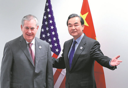Foreign Minister Wang Yi and US Secretary of State Rex Tillerson meet on the sidelines of a gathering of foreign ministers of the G20 leading and developing economies at the World Conference Center in Bonn, Germany, on Friday.  (Photo/China News Service)